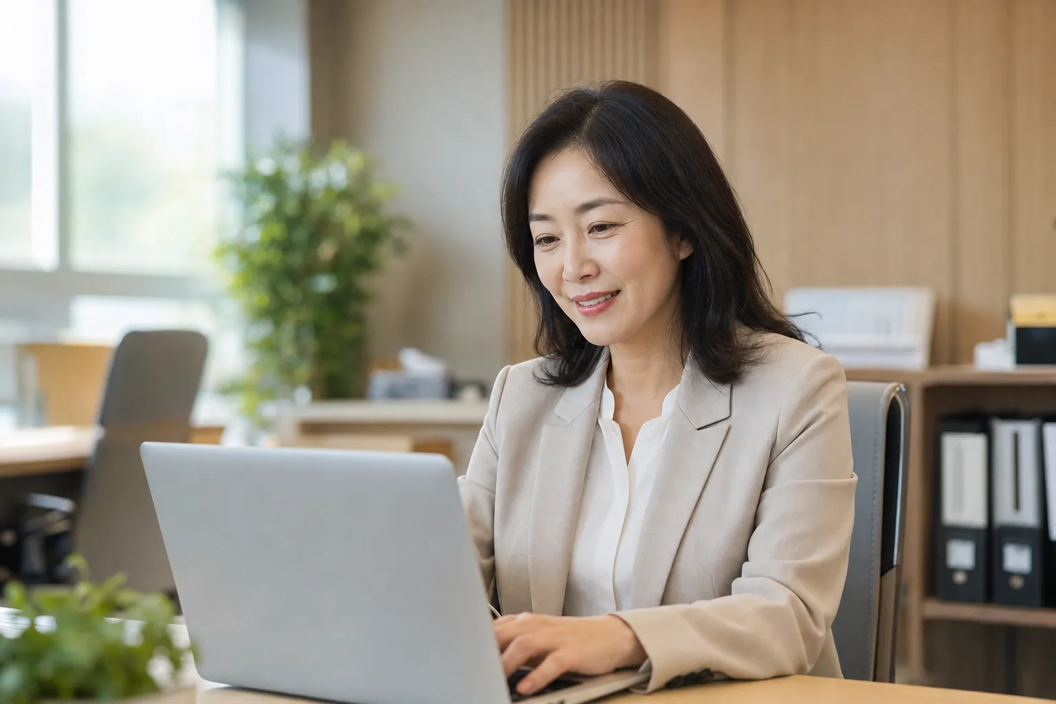 A coordinator reviewing operations on a laptop